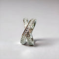 Silver and rose gold metal ring with a small cross design featuring micro-inlaid zircon stones.