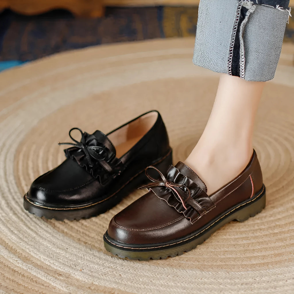 Black British style women's leather shoes with round toe and chunky flat heel on a white background.