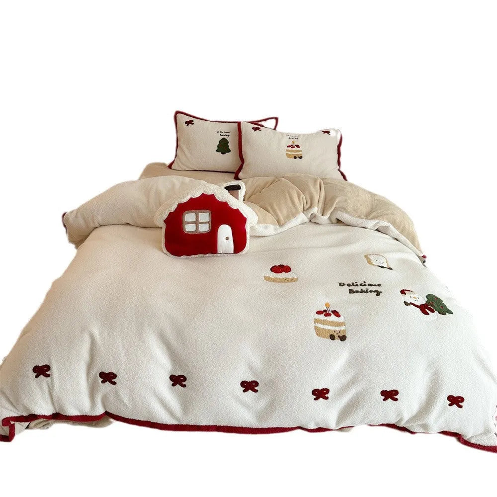 Winter Christmas cartoon patterned four-piece bedding set showing duvet cover, bed sheet, and pillowcases on a bed.