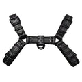 Black leather chest strap for men with metal buckle and rivet details on a mannequin.