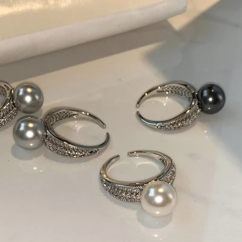 Geometric black pearl open finger ring with adjustable copper construction on female hand
