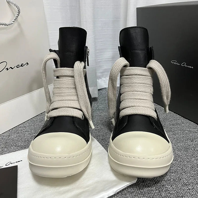 Men's and women's black high-top leather shoes with a side zipper and visible stitching on a round toe