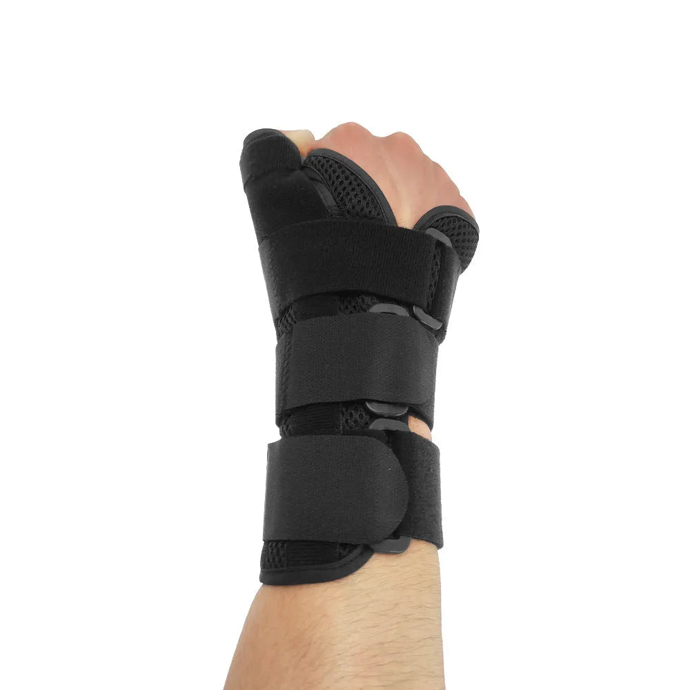 Black carbon fibre sports wrist guard with grey edging and adjustable thumb strap on athletic hand