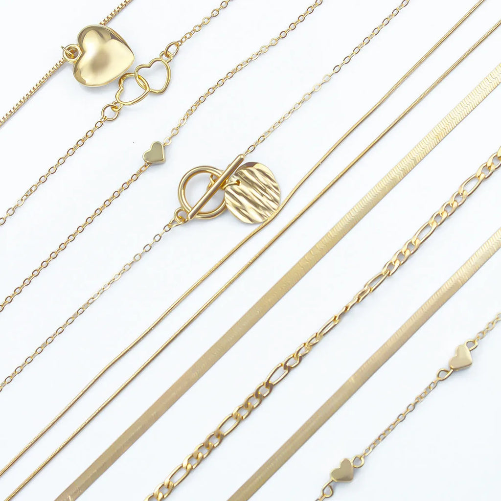 Set of 10 gold electroplated necklaces with alloy pendants on snake bone chains