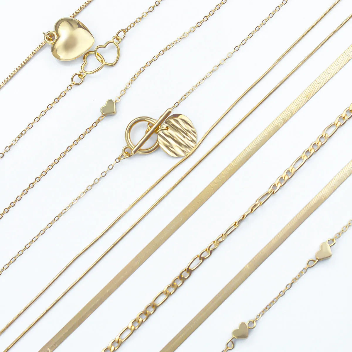 Set of 10 gold electroplated necklaces with alloy pendants on snake bone chains