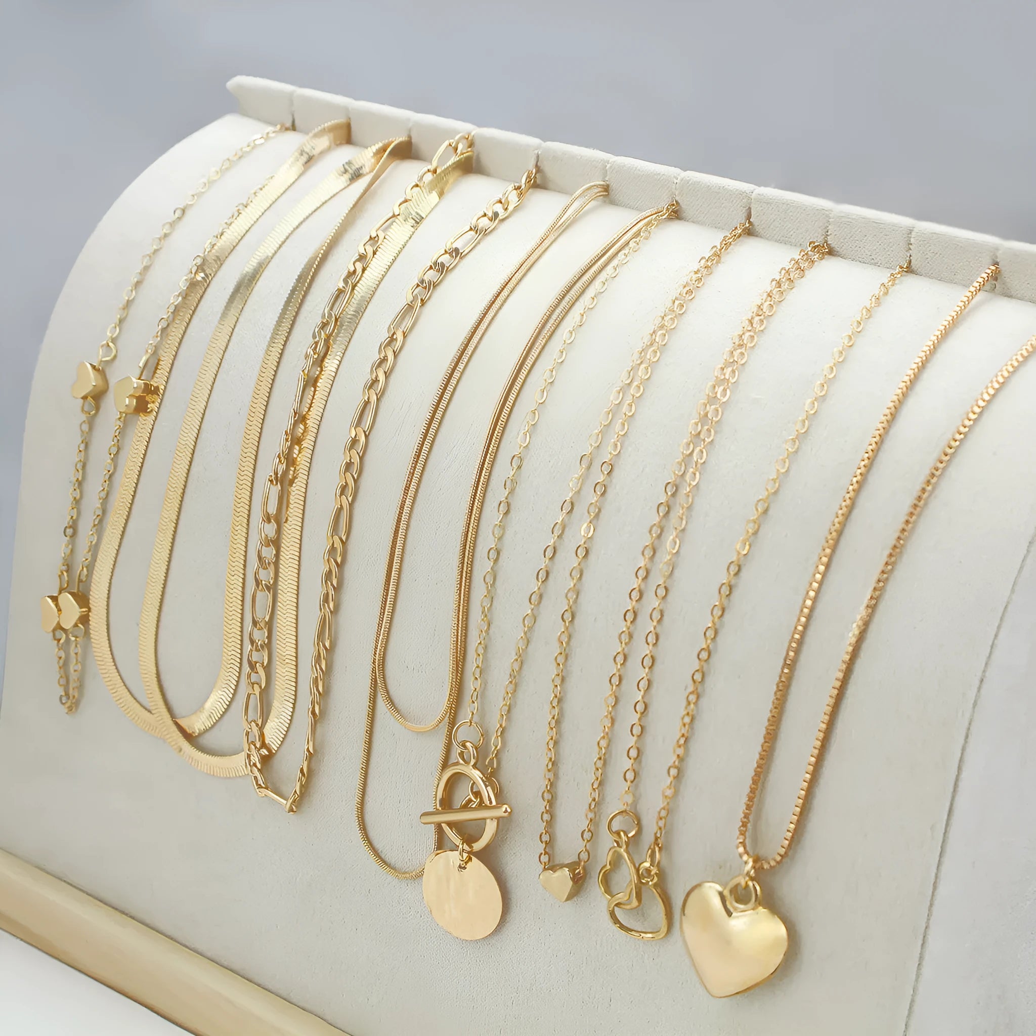 Set of 10 gold electroplated necklaces with alloy pendants on snake bone chains