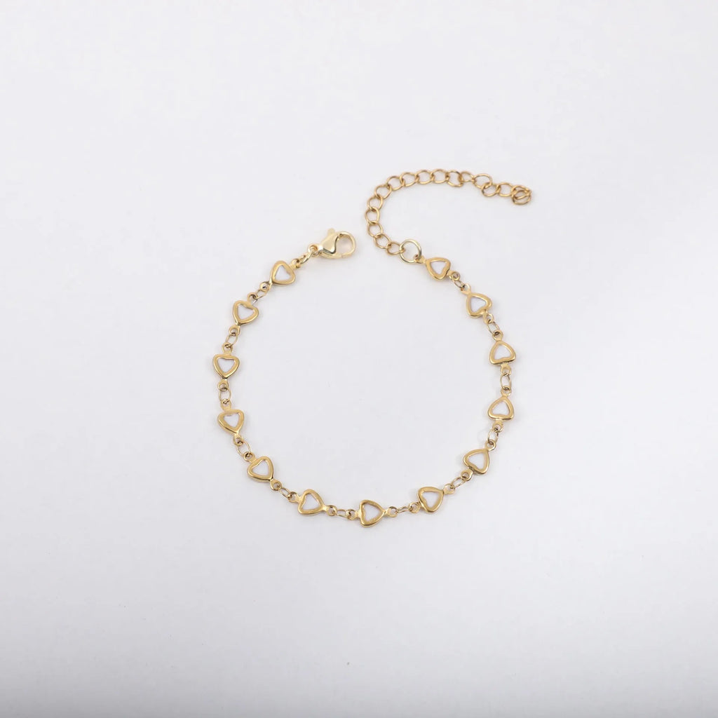 Stainless steel heart-shaped bracelet with a gold-plated finish on a wrist, showing the 17+5cm adjustable chain.