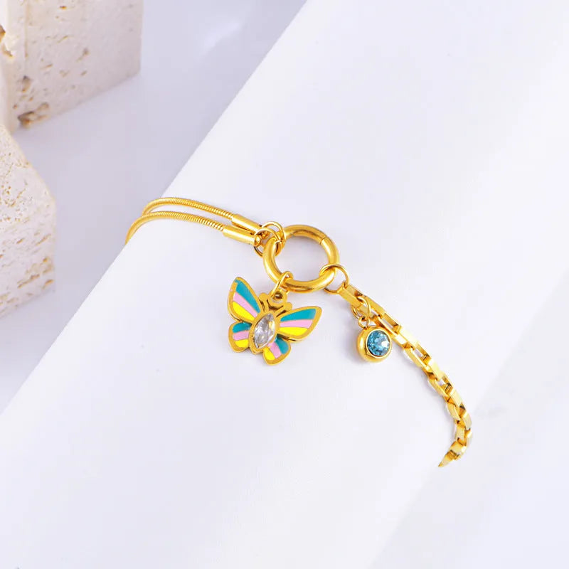 Gold titanium steel necklace and bracelet set with colourful epoxy butterfly pendants on snake bones chains.