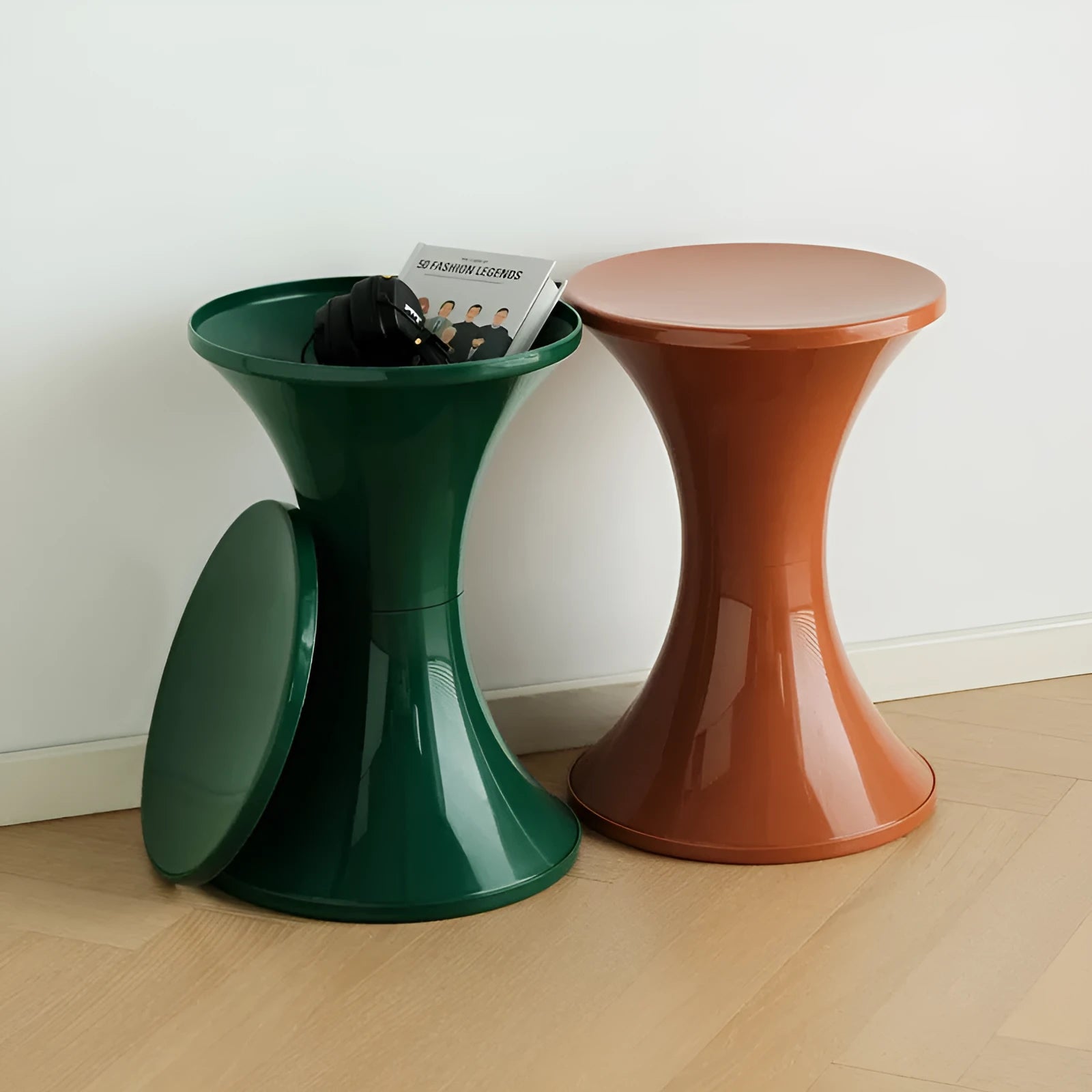 Hourglass-shaped plastic shoe changing stool in green colour on a wooden floor.
