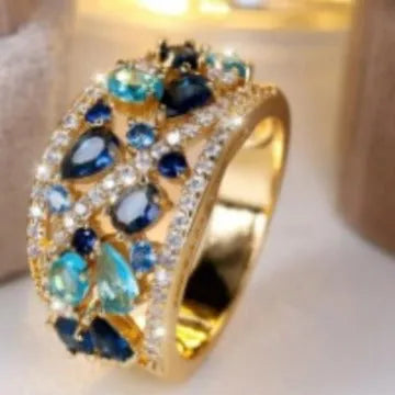 Women's hollow round copper fashion ring shown in gold and platinum colour finishes with a sizing chart.