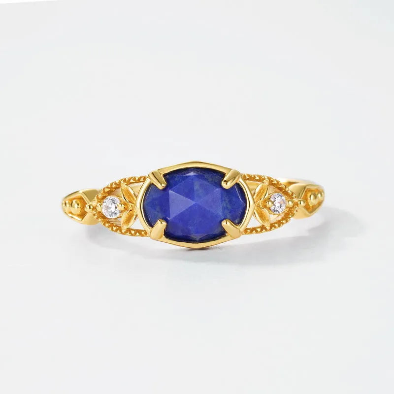Geometric silver ring with deep blue lapis lazuli stone, elliptical shape with round decorative elements