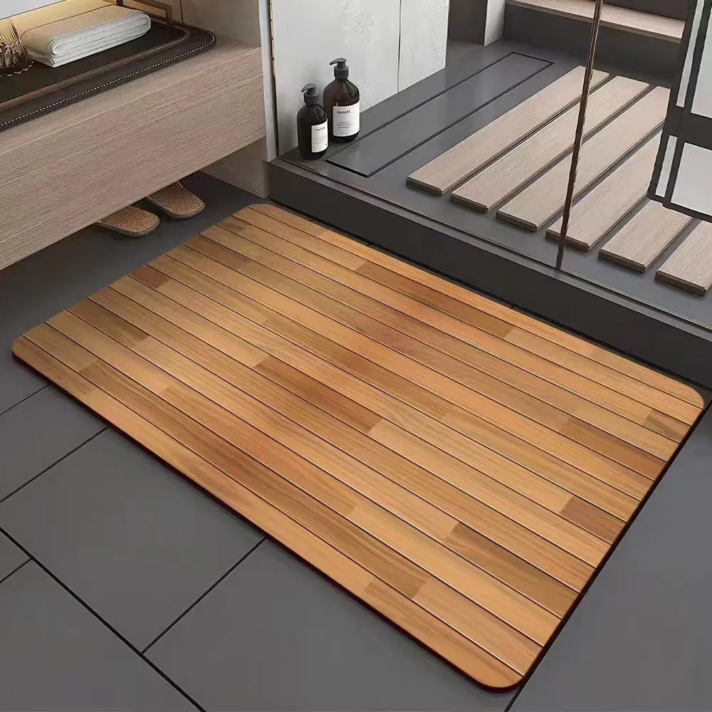 Square diatom mud bathroom floor mat with wood grain geometric pattern in front of a washroom door.
