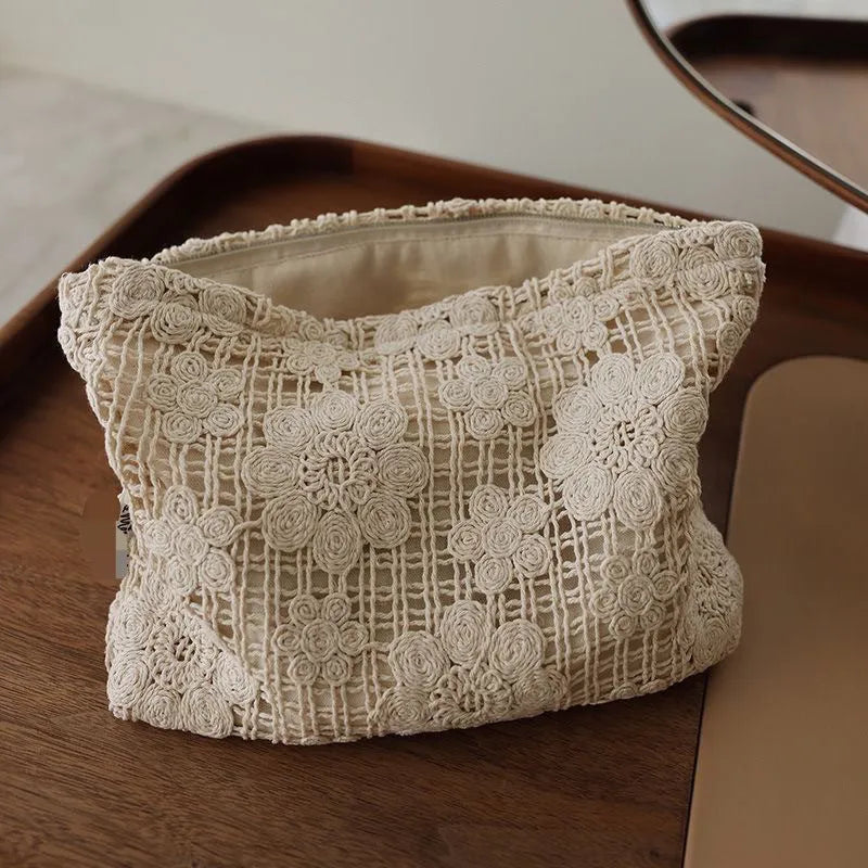 Handmade crocheted hollow flower cosmetic bag in corduroy with ethnic embroidery, solid rope colour.