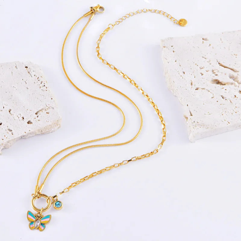 Gold titanium steel necklace and bracelet set with colourful epoxy butterfly pendants on snake bones chains.