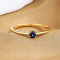 A simple single diamond fine circle ring for women in copper, shown in blue, green, red, and white colour options.