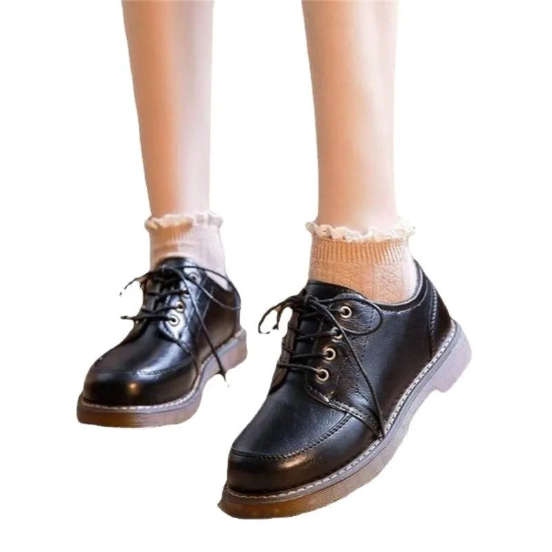Women's preppy style brown retro Mary Jane pumps with round toe and front lace-up closure on a white background.