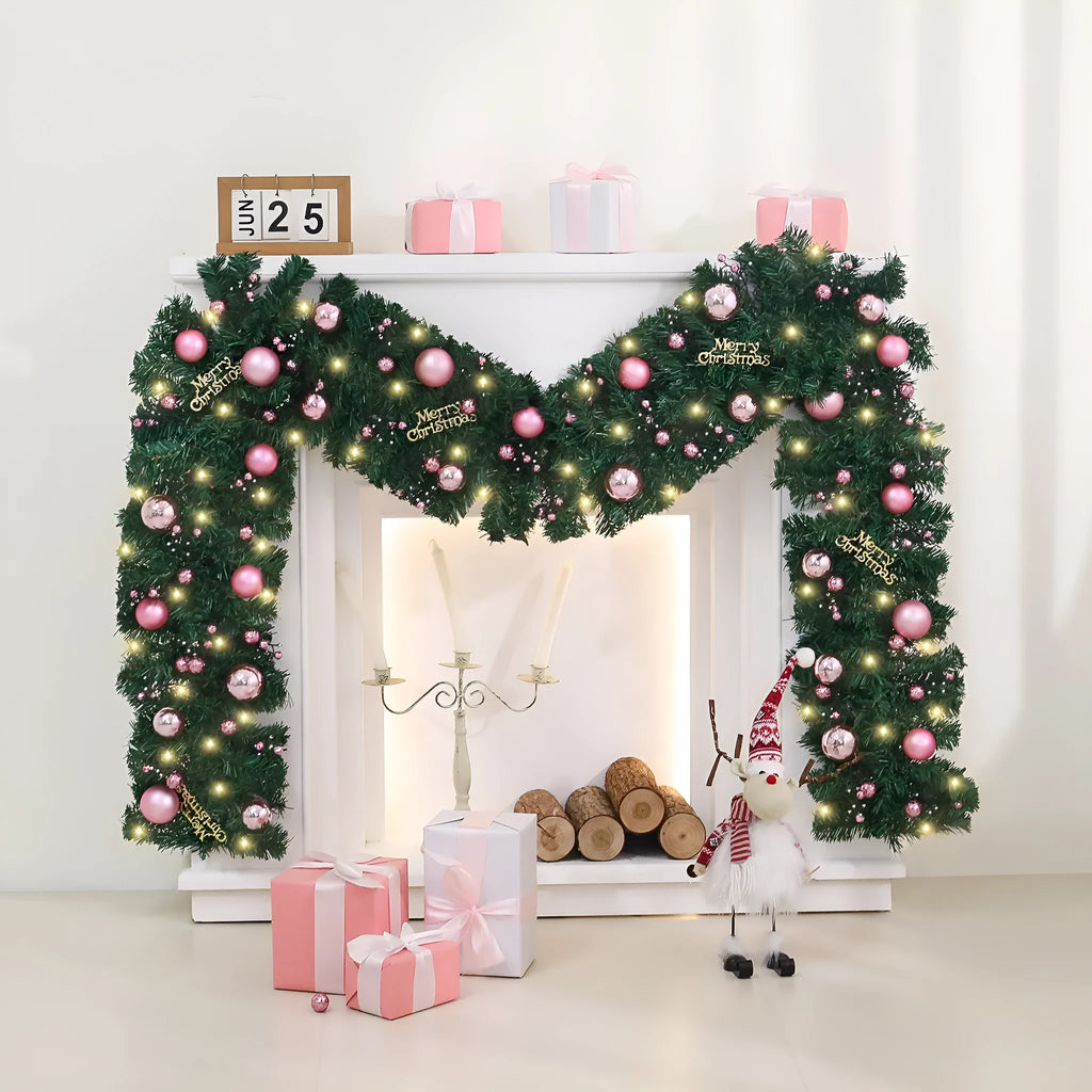 2.7 metre pink Christmas rattan garland with small fruit details and LED string lights displayed along mantelpiece