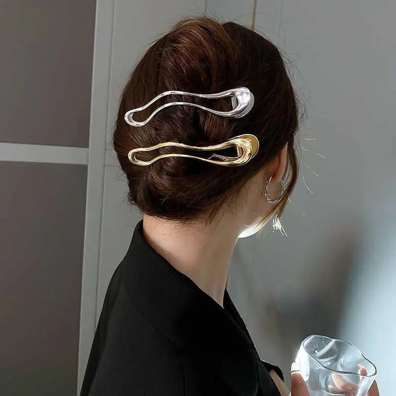 Women's zinc alloy hair barrette in gold colour with a triangle geometric design.