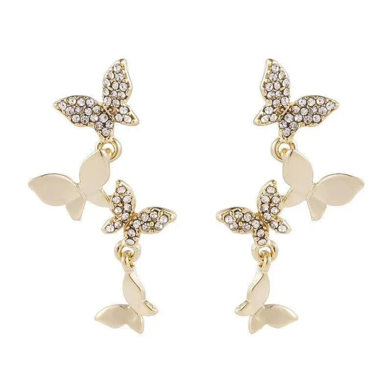 Women's butterfly copper earrings with gold-coloured drops and natural style design