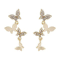 Women's butterfly copper earrings with gold-coloured drops and natural style design