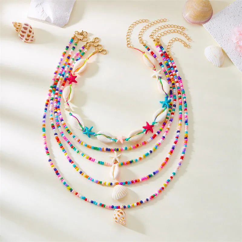 Women's starfish shell bead necklace 5-piece set with electroplated alloy pendants showing blue and mixed colour variations