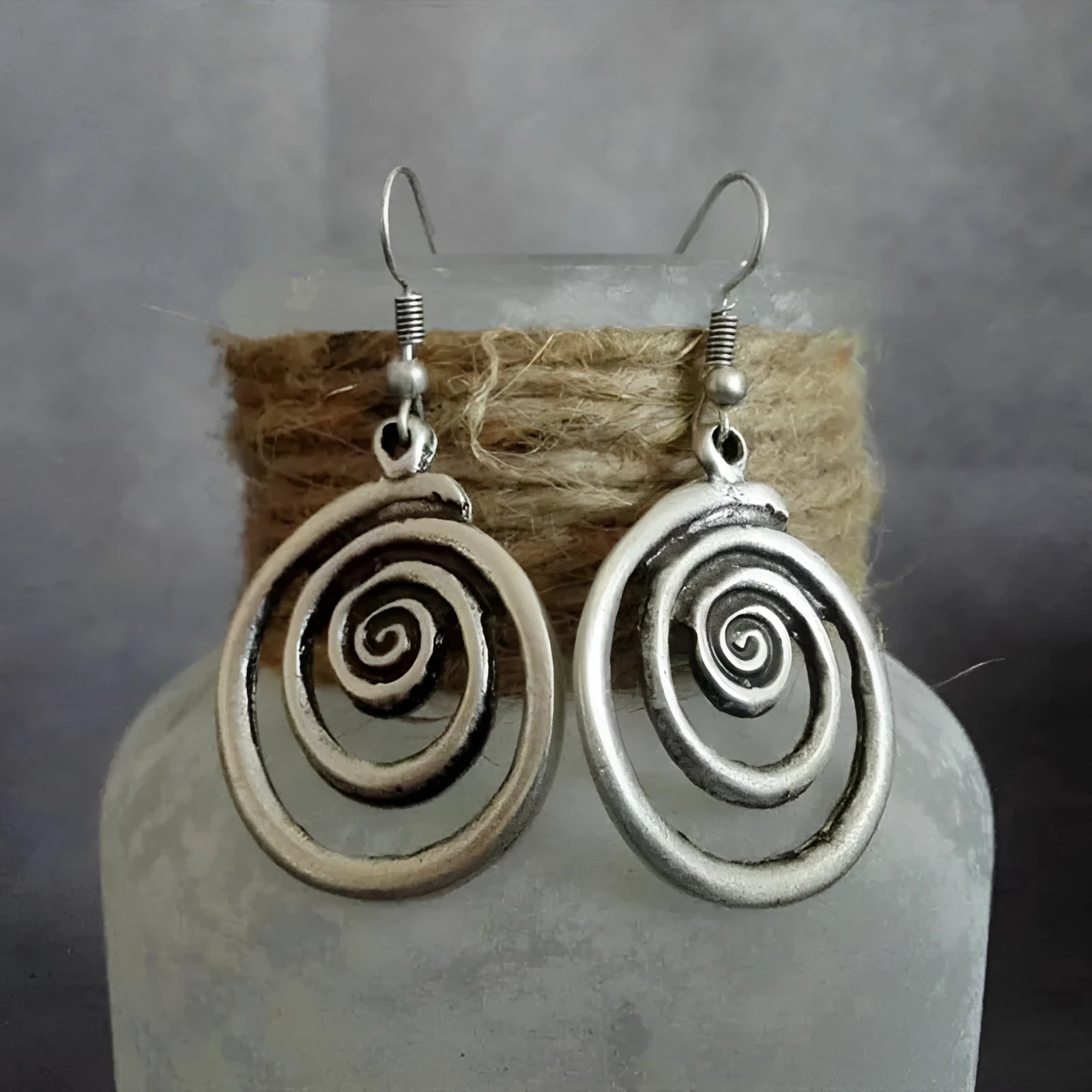 Silver geometric spiral earrings with distressed finish and national style design