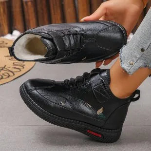 Women's black velvet house shoes with a non-slip rubber sole and hollow-out pattern