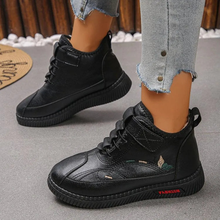Women's black velvet house shoes with a non-slip rubber sole and hollow-out pattern
