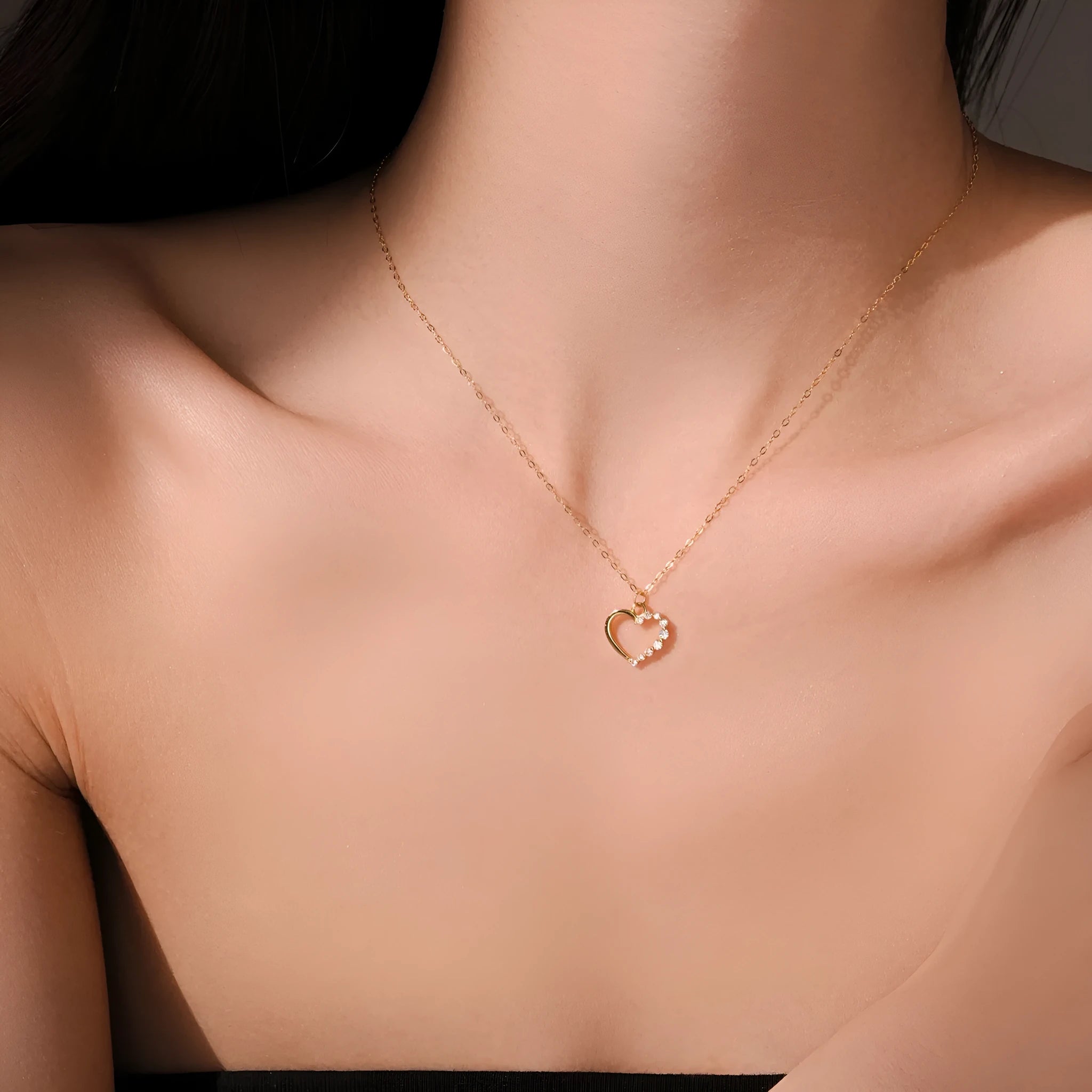 Close-up of a sterling silver hollow heart pendant necklace on a regular chain.