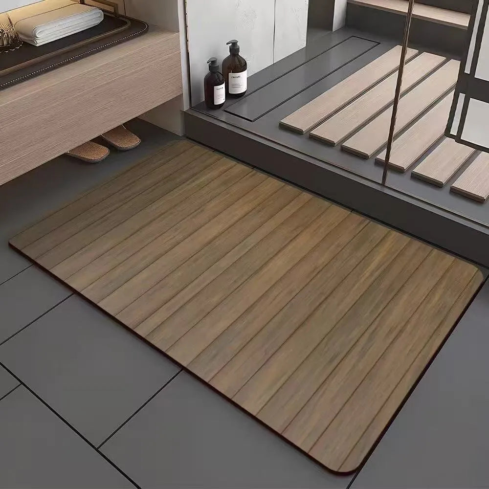 Square diatom mud bathroom floor mat with wood grain geometric pattern in front of a washroom door.