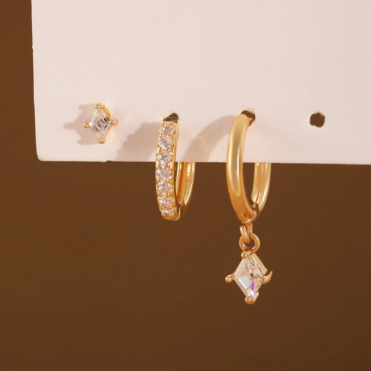 Geometric zircon earring three-piece set showing ear ring, stud, and clasp in gold and silver colours