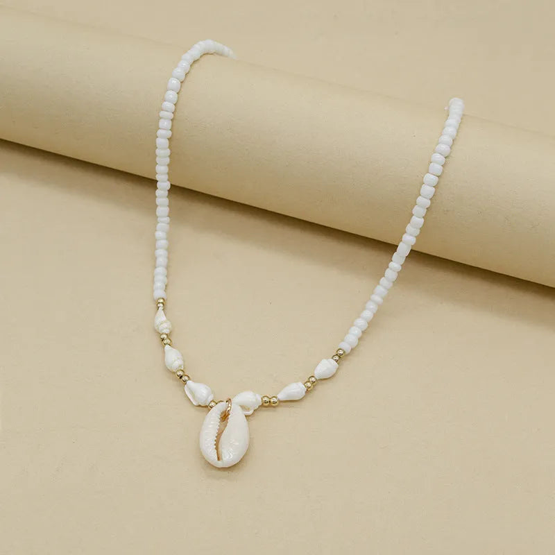 White women's necklace with a natural mother-of-pearl shell pendant on a regular chain.