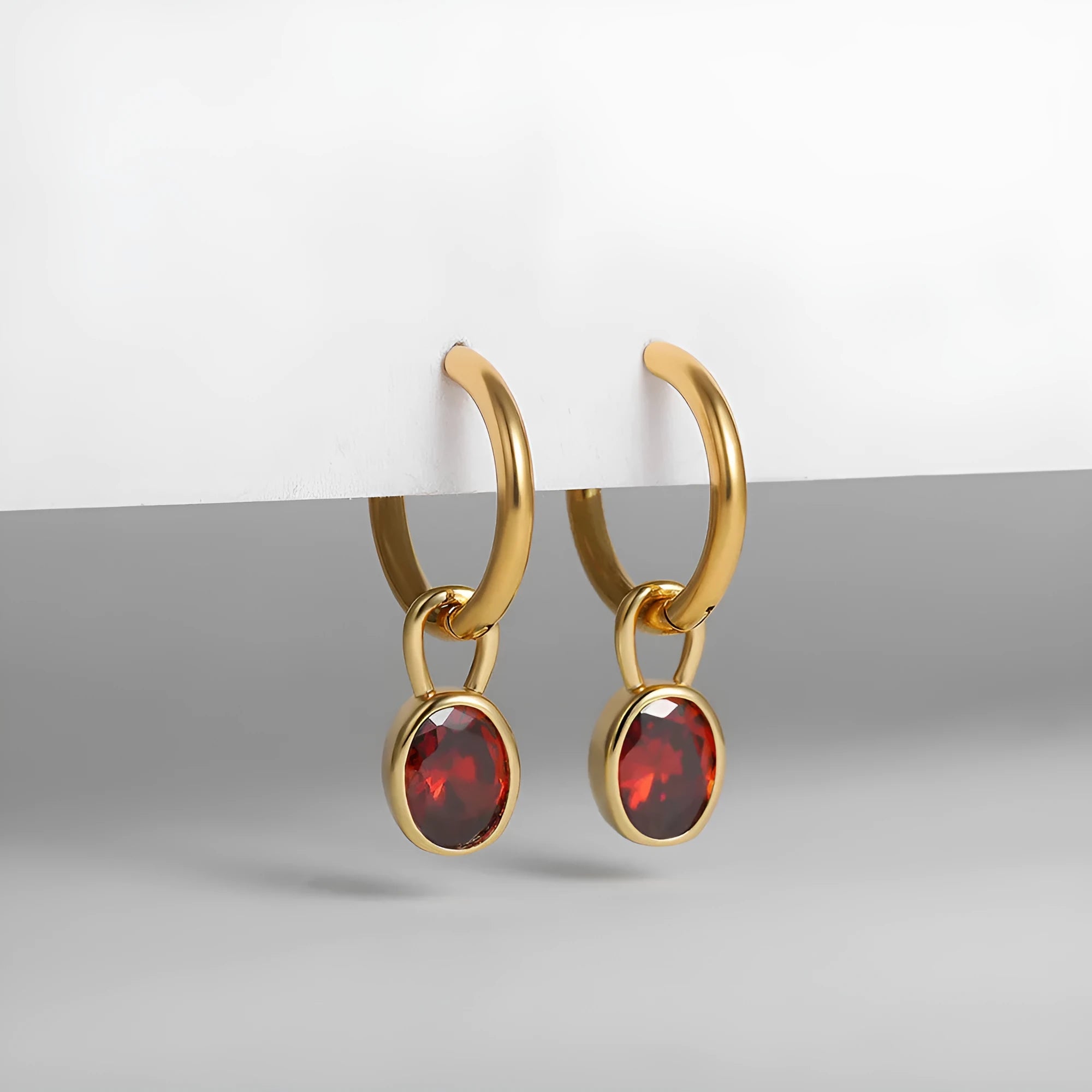 Women's oval zircon earrings in copper on a post, shown in army green colour.
