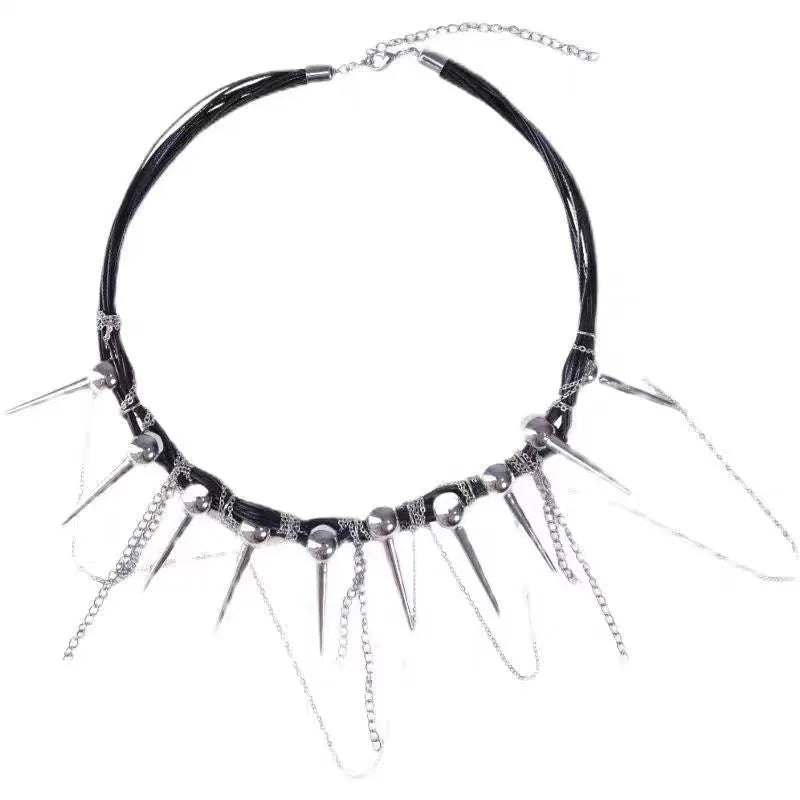 Leather necklace with winding round beads, metallic rivet details, and a long tassel in an electroplated finish.