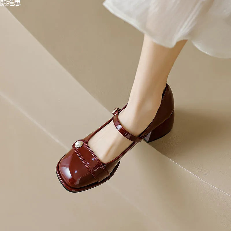 Women's apricot patent leather chunky heel pumps with a square toe and silver buckle fastening.