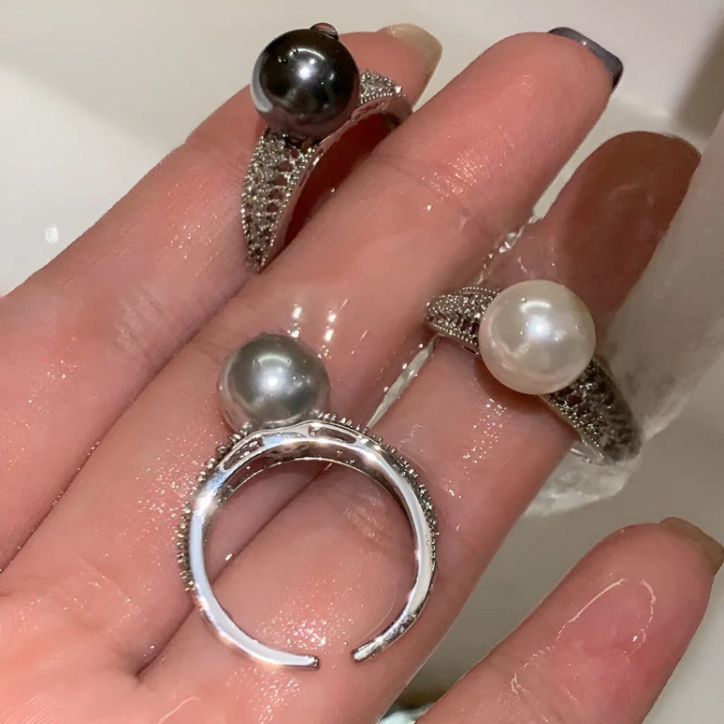 Geometric black pearl open finger ring with adjustable copper construction on female hand