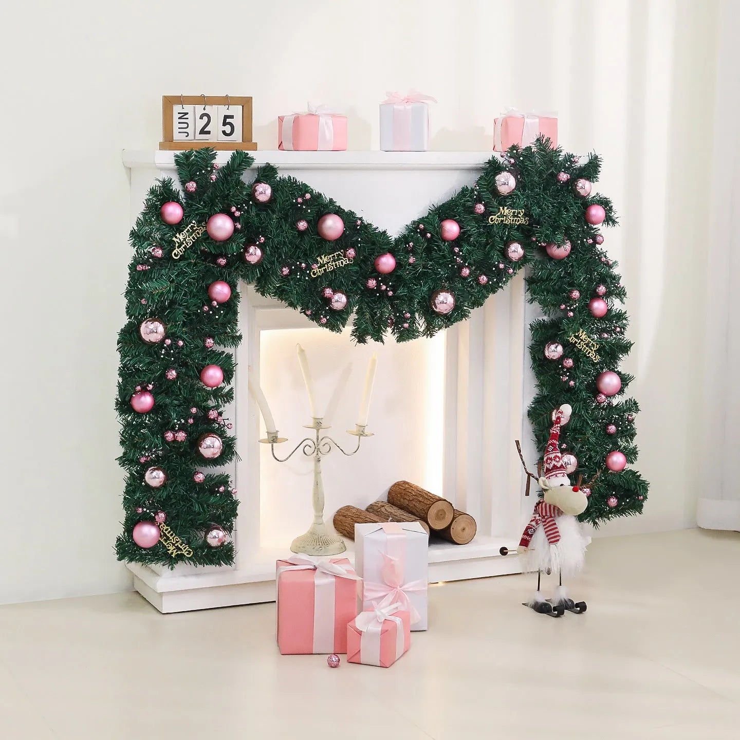 2.7 metre pink Christmas rattan garland with small fruit details and LED string lights displayed along mantelpiece