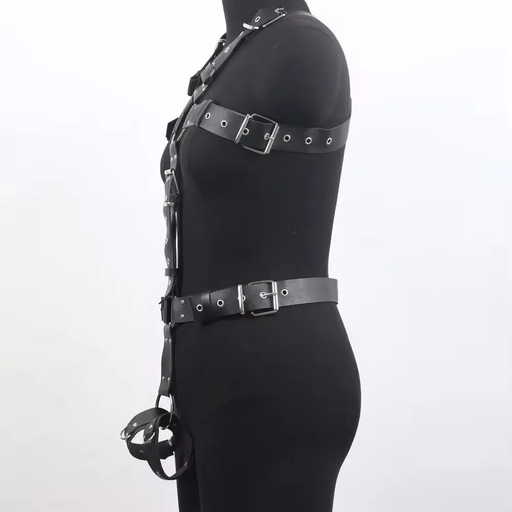 Black patent leather bondage belt with a thin width and silver-tone pin buckle on a dark background.