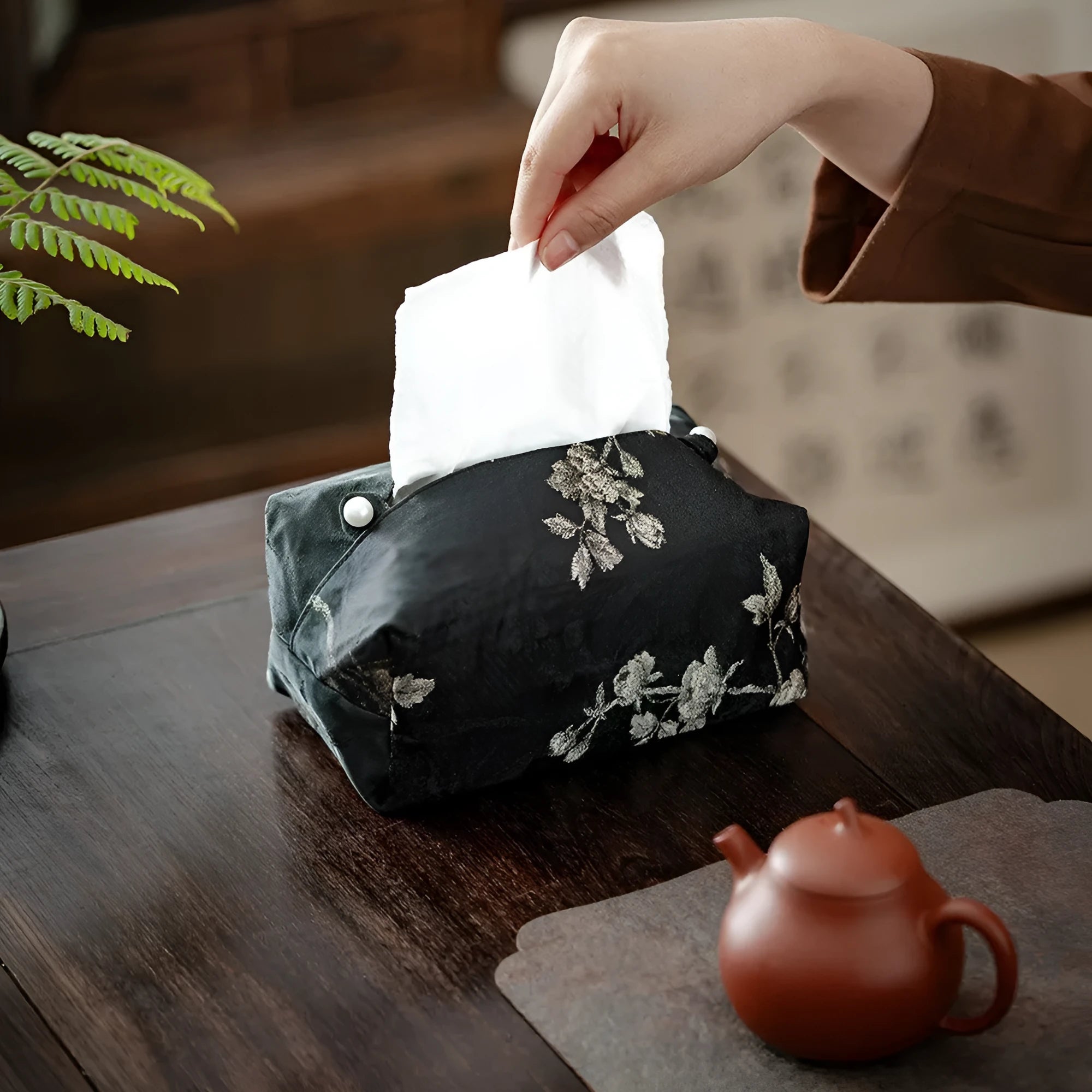 Chinese brocade fabric tissue box with embroidered white plum design, shown with and without a pearl buckle.