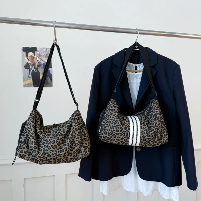 Cloth messenger bag with leopard print pattern showing cross-body strap and stitching details