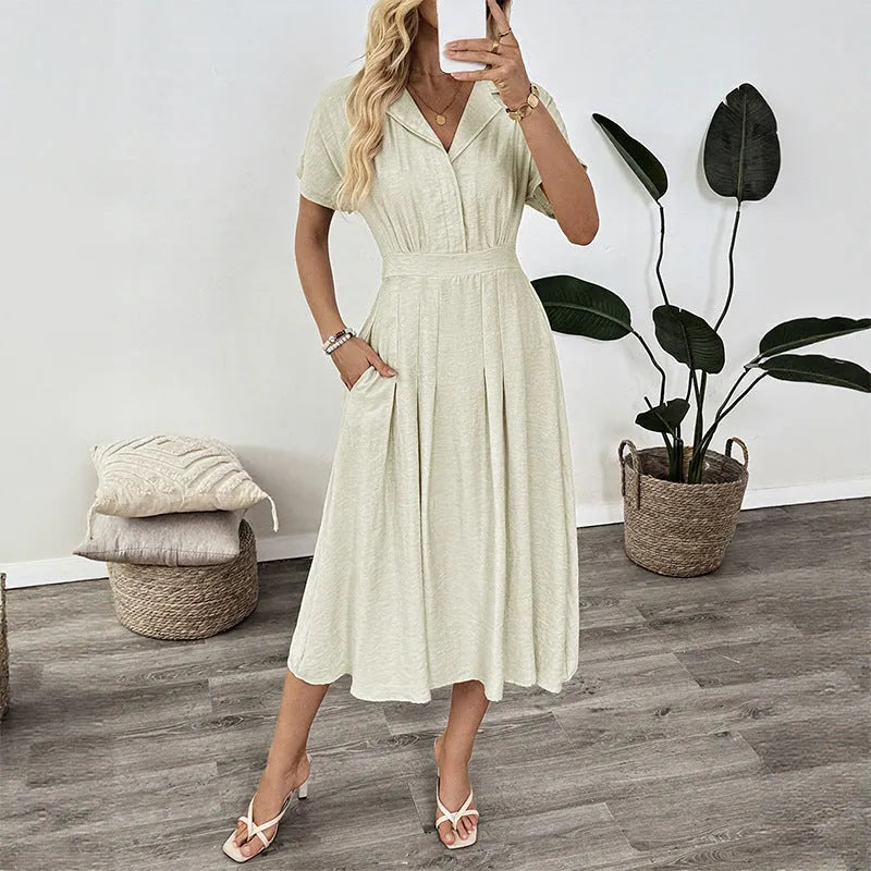 Light green women's shirt dress with lapel collar, defined waist, and pockets on a model.