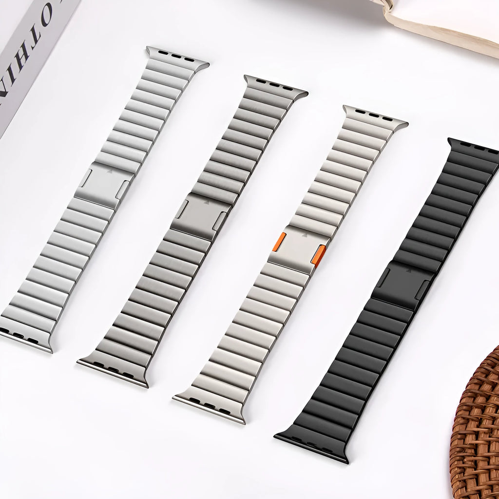Stainless steel Apple Watch strap with magnetic fold-over buckle in silver colour.