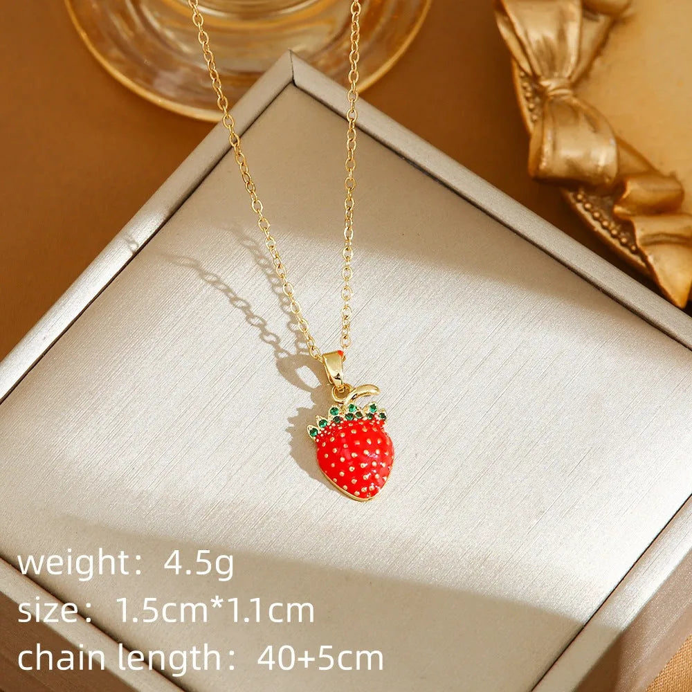 Titanium steel necklace with O-ring chain and a delicate cherry pendant in a gold-tone finish.