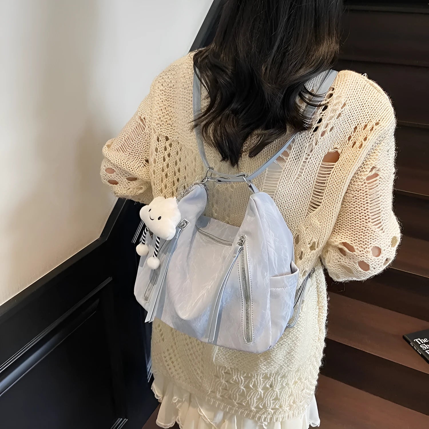 Soft PU women's fashion backpack in blue colour with a matching pendant.