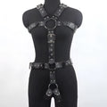 Black patent leather bondage belt with a thin width and silver-tone pin buckle on a dark background.