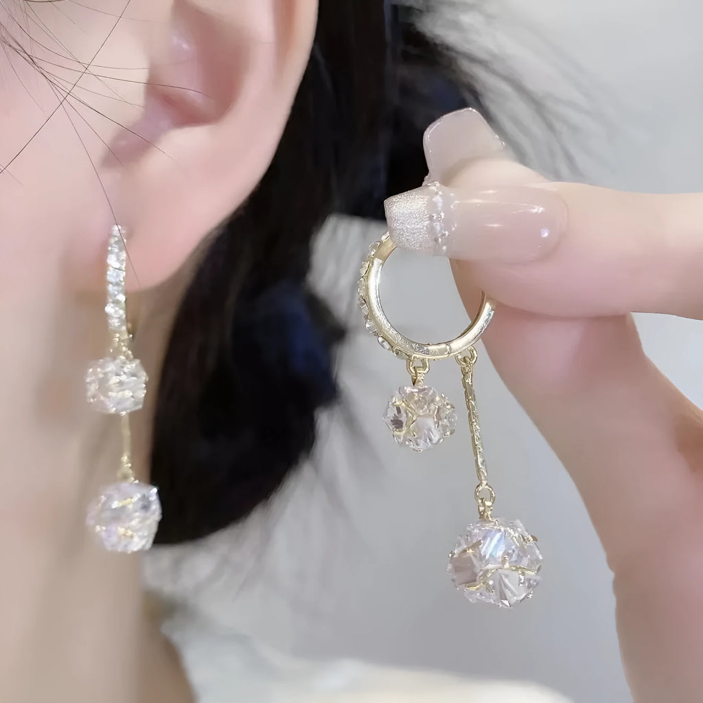 Silver colour women's earrings with tassel ball and rhinestone accents featuring confession balloon motif