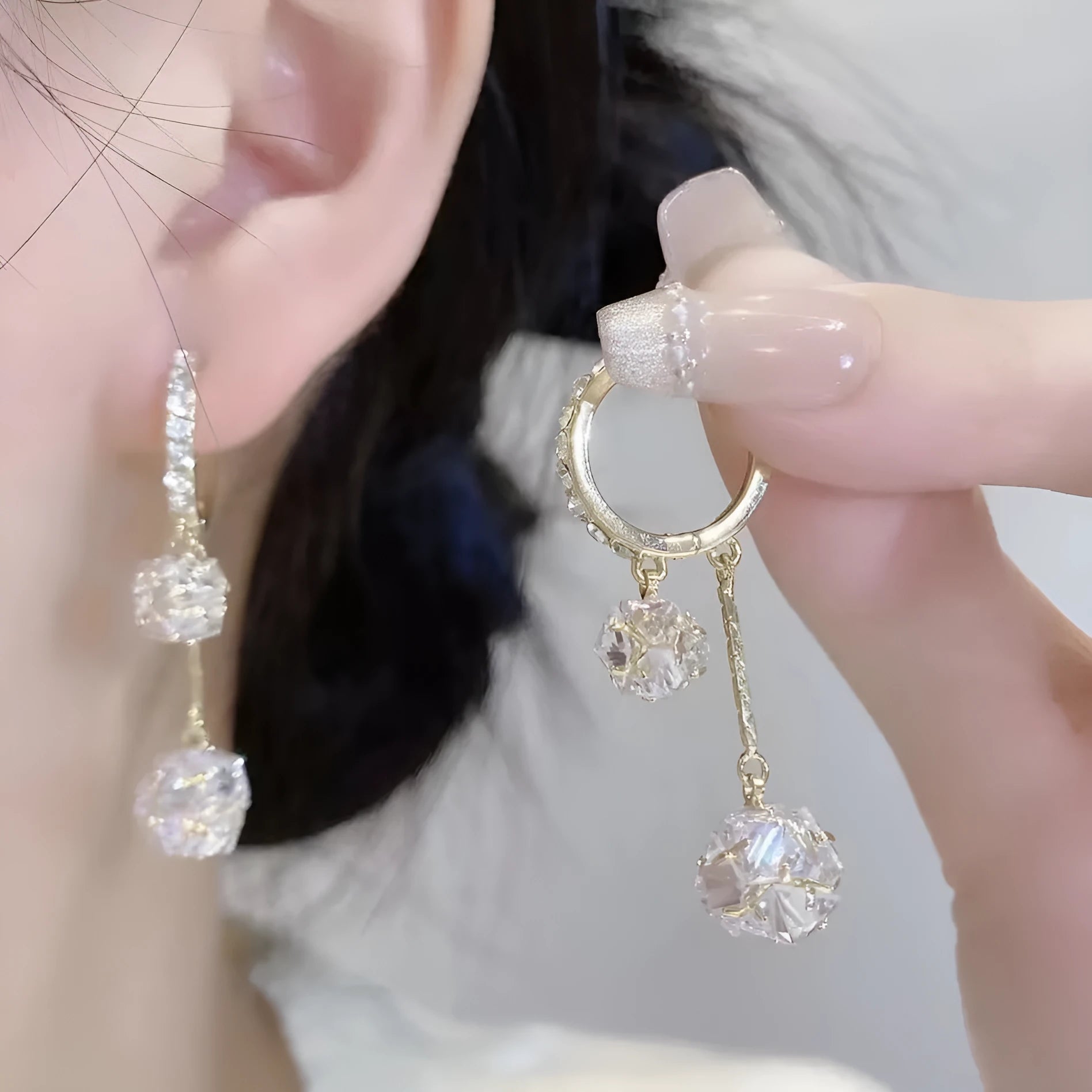 Silver colour women's earrings with tassel ball and rhinestone accents featuring confession balloon motif
