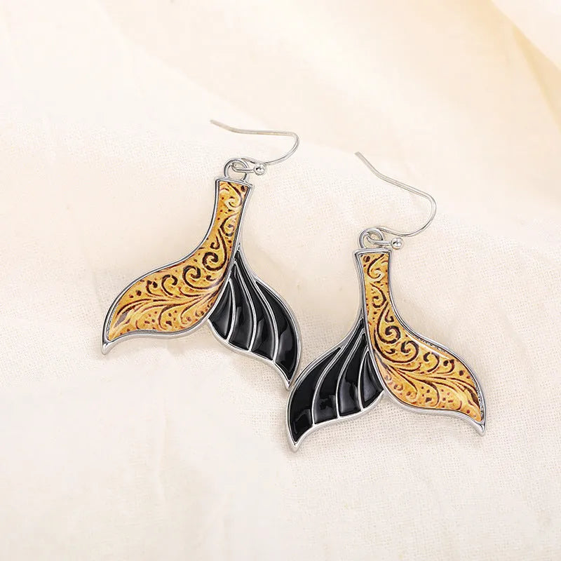 Women's fishtail shaped earrings with whale design in white gold colour alloy