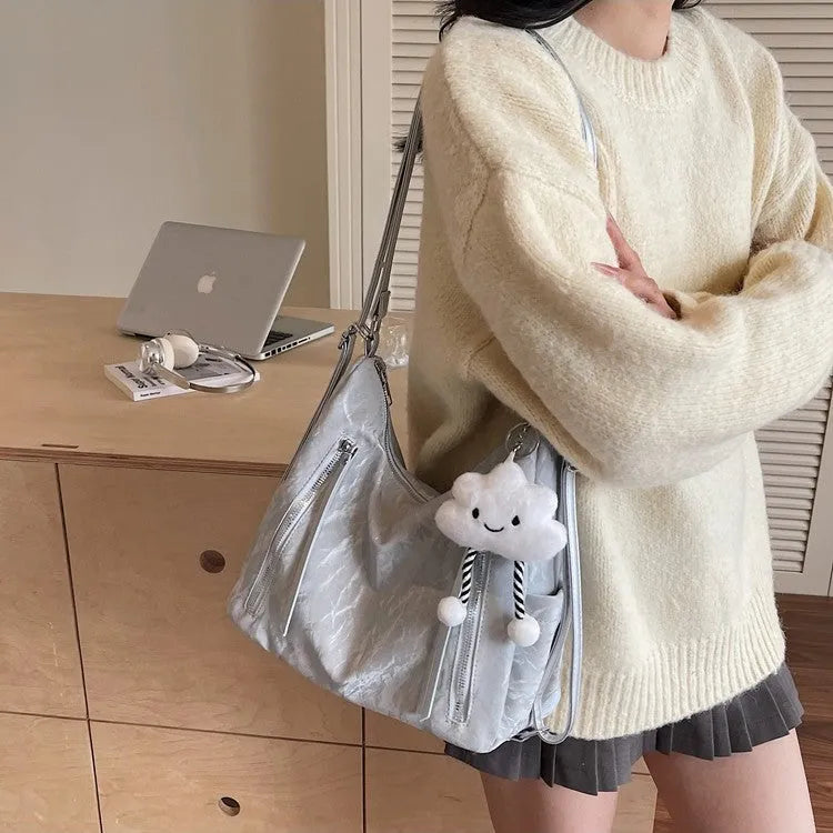 Soft PU women's fashion backpack in blue colour with a matching pendant.