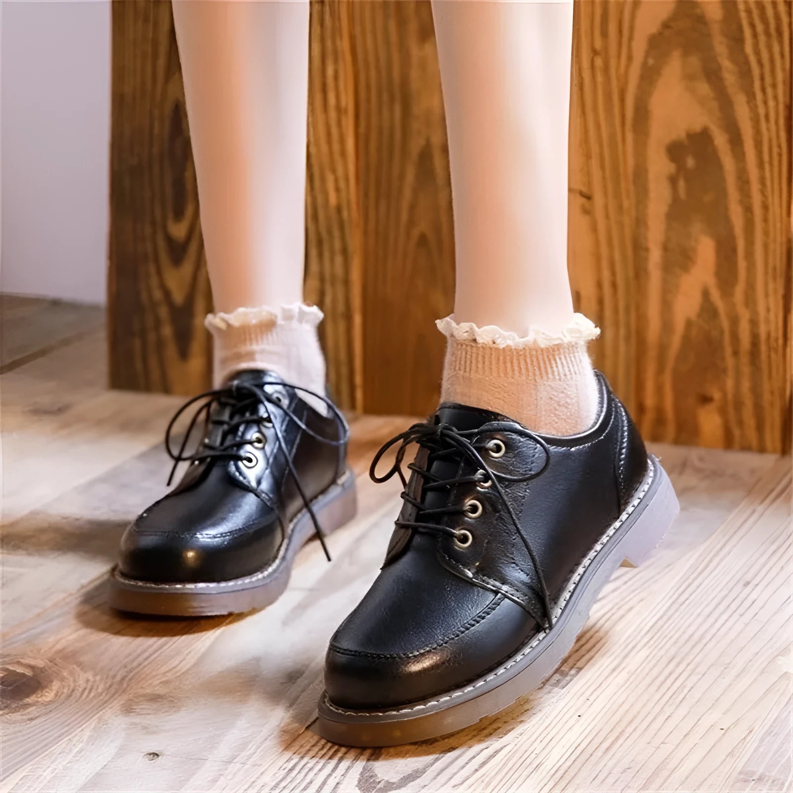 Women's preppy style brown retro Mary Jane pumps with round toe and front lace-up closure on a white background.